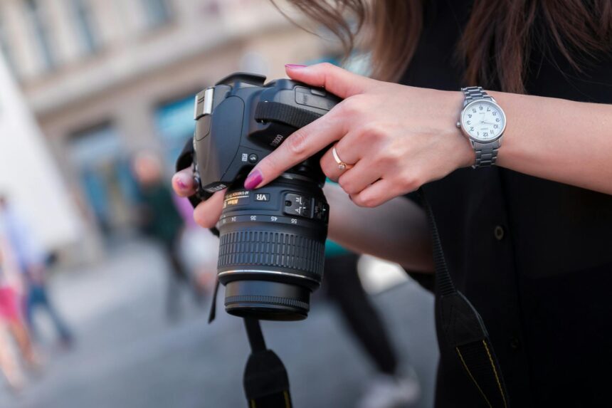 woman holding black dslr camera