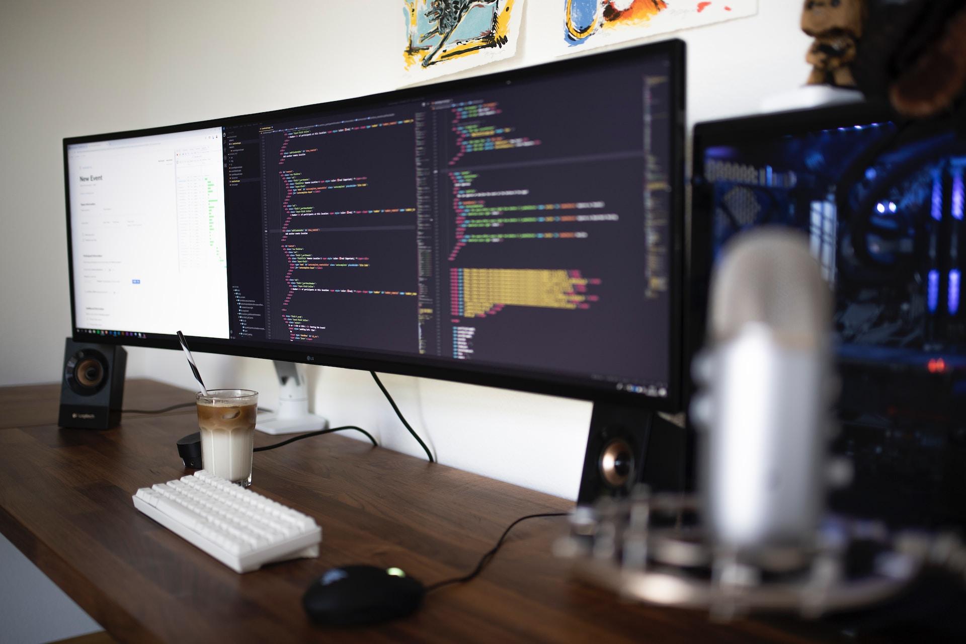 An image showing computer monitors with various code and analytics pertaining to cloud computing.