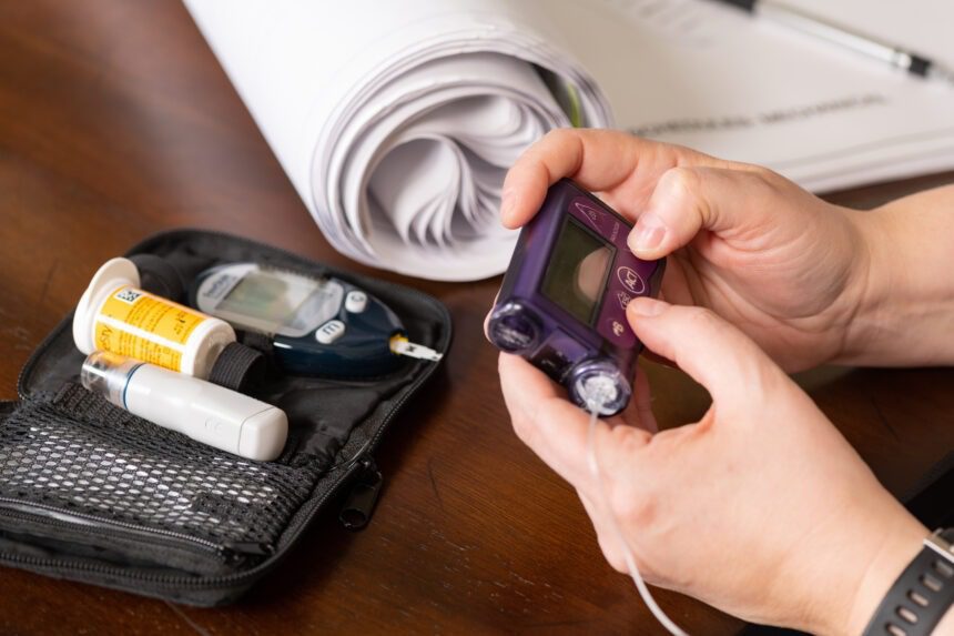 Woman working while using insulin pump to control type 1 diabetes