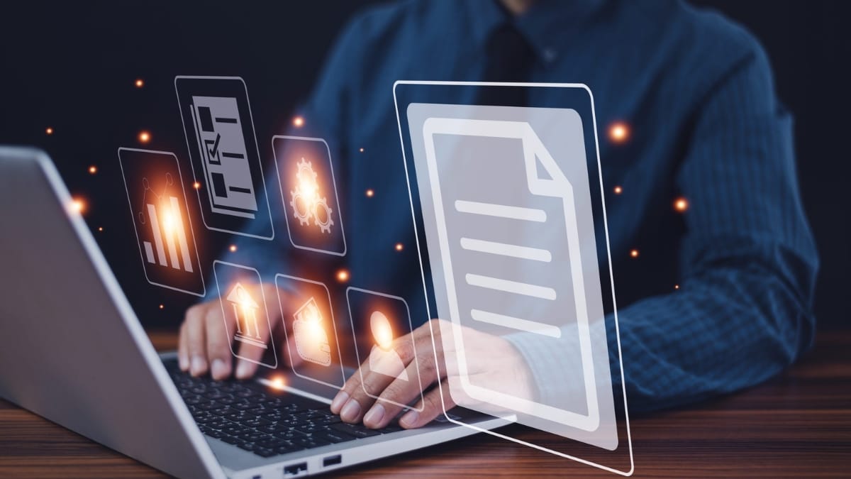 Professional using laptop with digital document management and data digitization interface