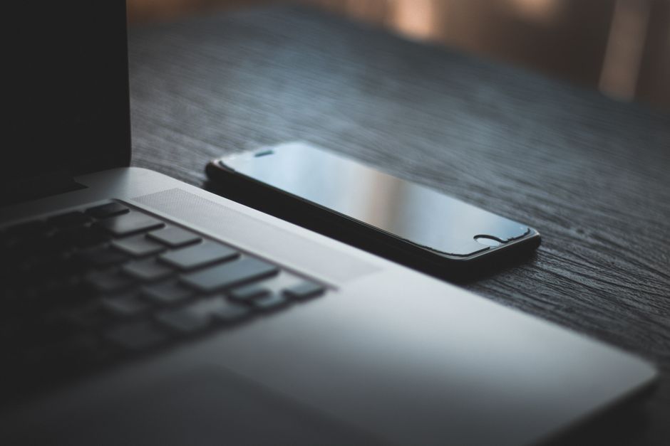 Laptop and smartphone side by side on a desk, tethered connection troubleshooting