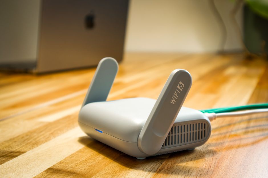 Modern Wi-Fi 6 router with antennas on a wooden desk