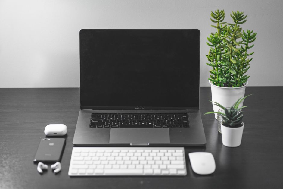 Clean desk setup with a laptop and smartphone