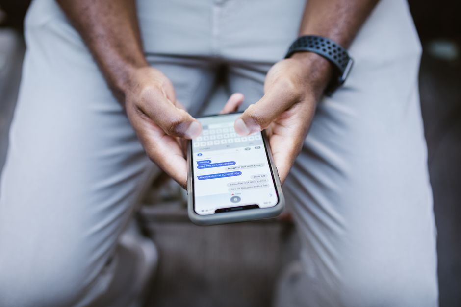 Close-up of a man texting on a smartphone