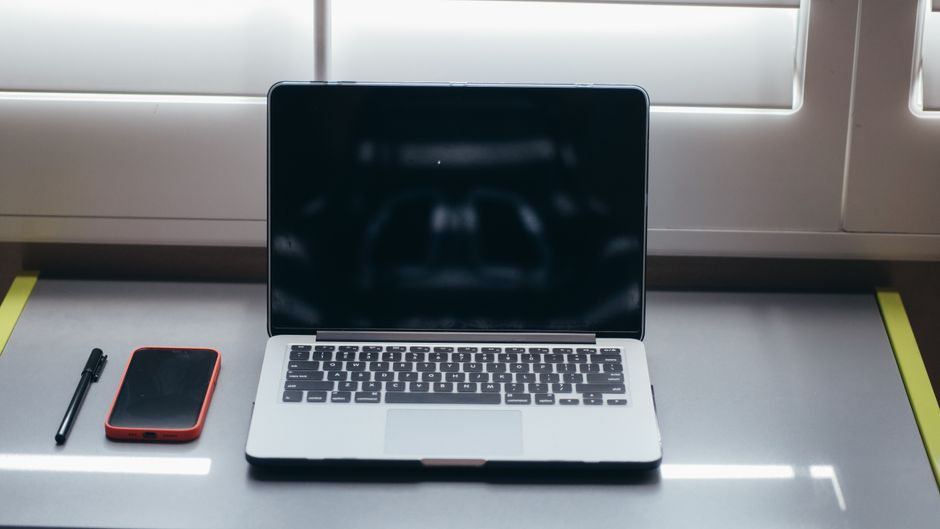 Minimalist desk with laptop and smartphone connected via hotspot