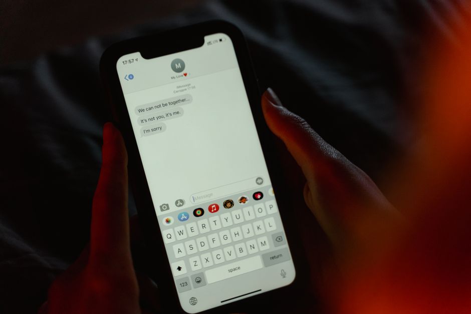 Hands holding a smartphone showing an incoming message