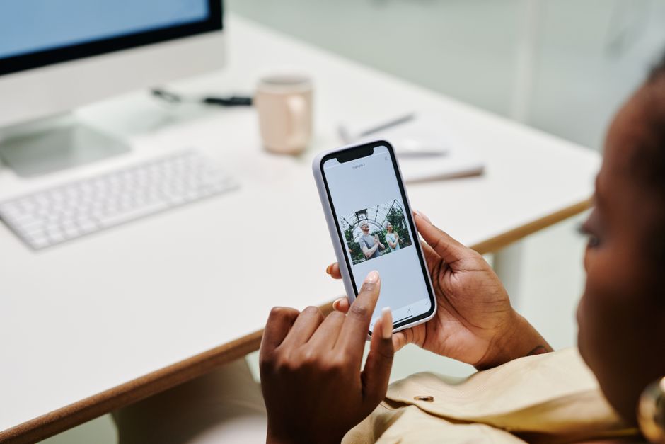 Person checking storage settings on an iPhone at a desk