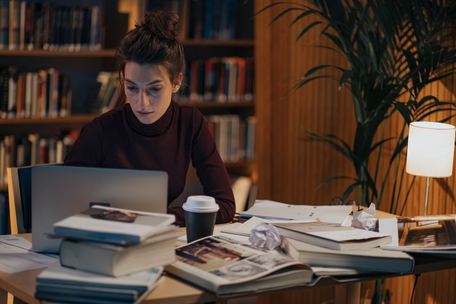 Person reviewing a large photo library on a laptop and phone side by side