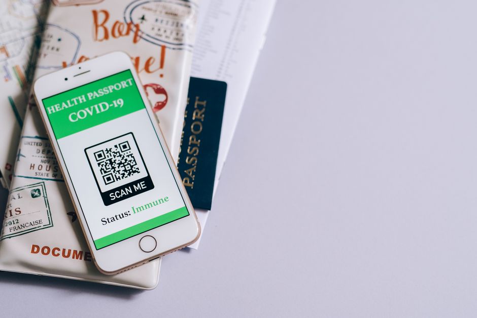 Smartphone displaying a digital document next to a passport on a table