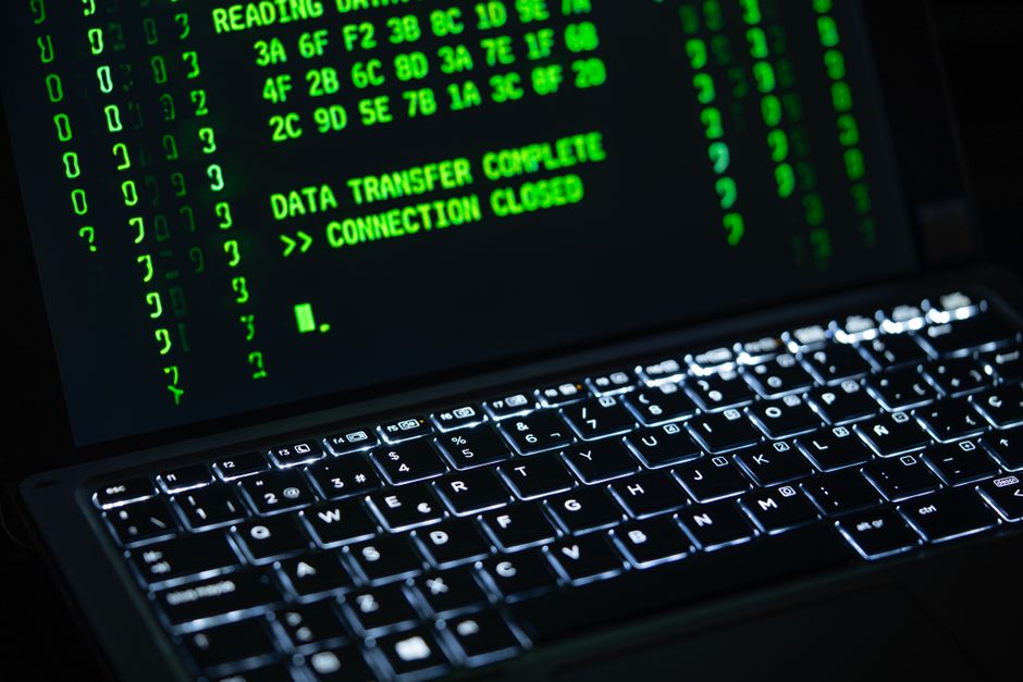 Close-up of a laptop screen with green code on it